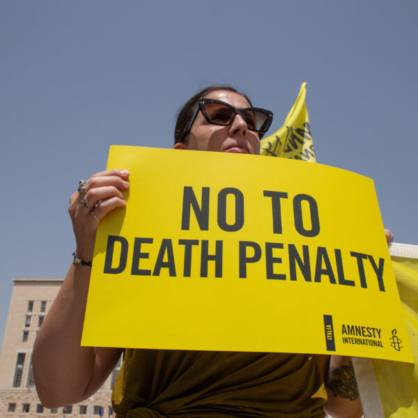 Attivista Amnesty International con cartello "no alla pena di morte".